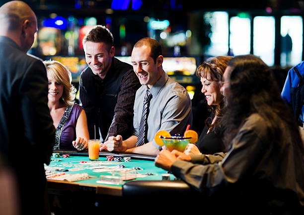 Live dealer casino table with roulette wheel and croupier